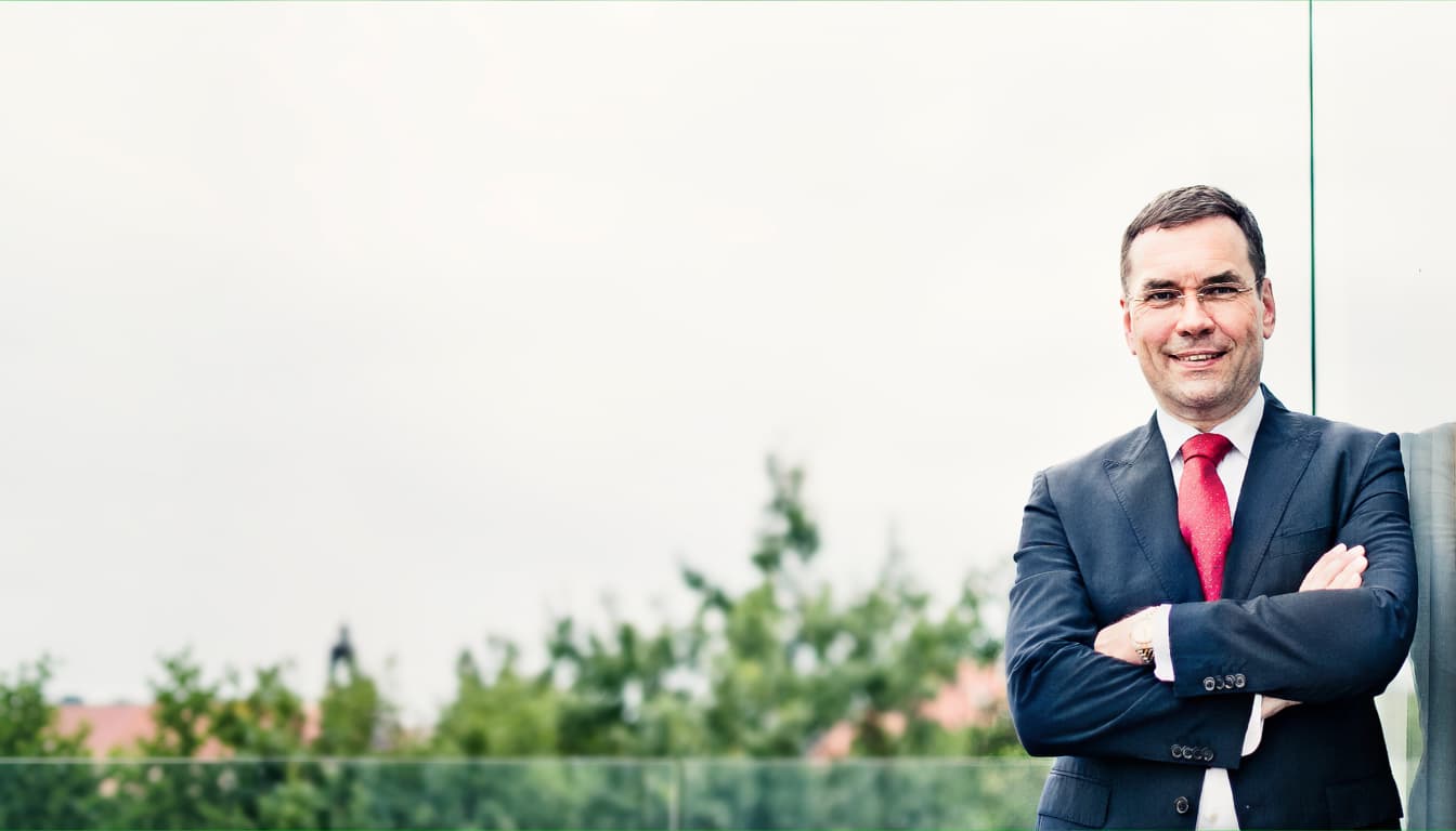 Adwokat Lutz Färber przed szklaną fasadą swojej kancelarii